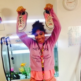 Image of a person we support holding shoes