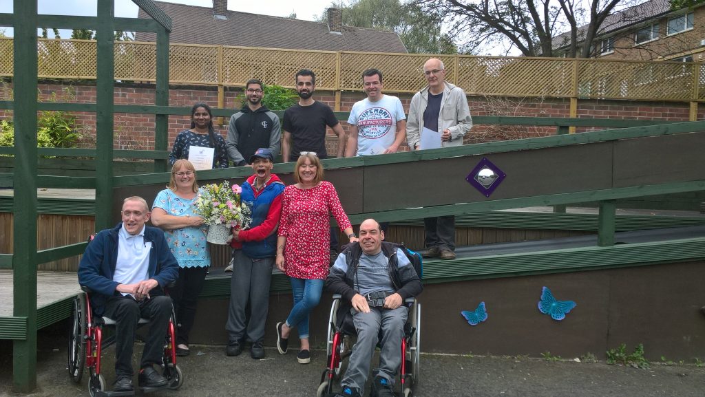 Volunteers and people we support in the transformed garden.