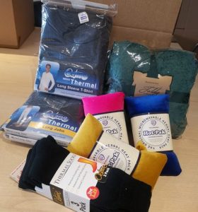 Four pairs of thermal socks, two thermal tops and a teal blanket