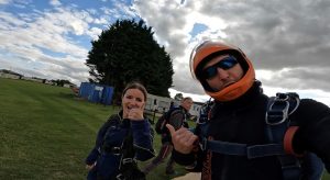 Angie, with her skydiving instructor , giving a thumbs up