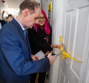 A yellow ribbon being cut to open the lounge