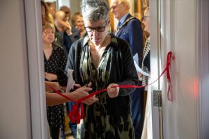 A red ribbon being cut to open the lounge