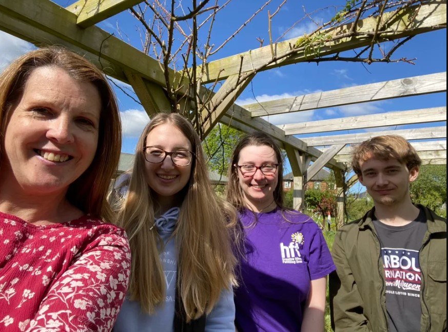 The students along with Community Fundraising Manager Emma enjoying their time in the sunny gardens of the service