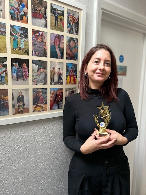 Hayley holding her trophy which features three gold shooting stars.