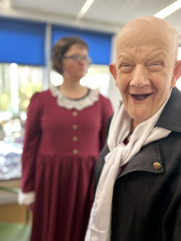 Two of the actors smiling. 