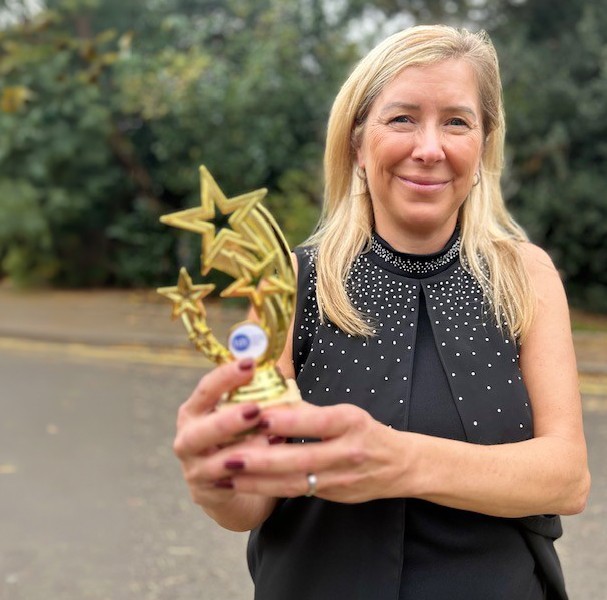 Helen with her trophy for Senior Support Worker of the Year at our Bedfordshire service.